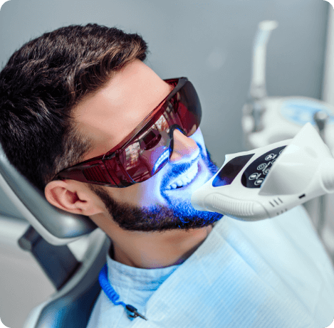 Man getting professional teeth whitening from cosmetic dentist