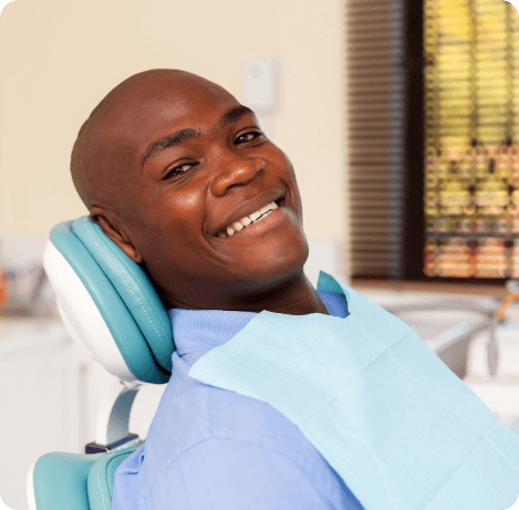 man smiling in dental chair during dental checkup