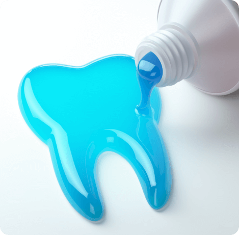 Blue toothpaste spilling out of tube into shape of tooth