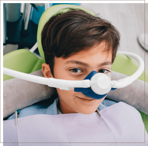 Young boy wearing nose mask for nitrous oxide sedation dentistry in Oklahoma City